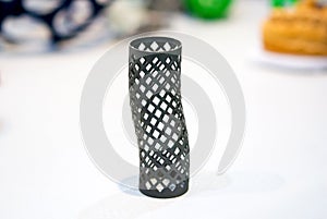 Object printed on metal 3d printer isolated on white background close-up.