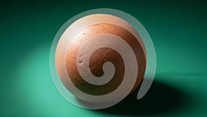 Object with a rough brown surface is placed against a smooth