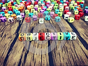 OBJECTIVE word of colourful cube alphabets. photo