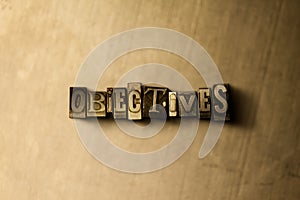 OBJECTIVES - close-up of grungy vintage typeset word on metal backdrop