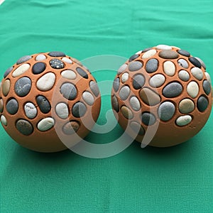 Objects covered in smooth multicolored pebbles embedded in a