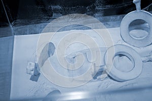 Objects printed 3D printer from powdered polyamide lying white polyamide powder