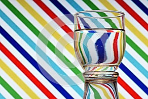 Oblique lines of colors reflected in a glass of water