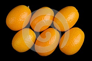 Oblique Oval Kumquats On Black Background