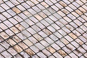 Oblique panel stone gray tiles with dark spots old mosaic roof many blocks background base