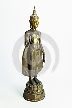 Oblique side of ancient Buddha metal statue isolated on white background photo