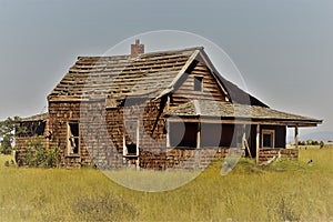 Oblique side angle view of an abandoned farm house with zeke enhancement photo