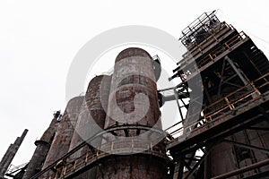 Oblique view of abandoned steel mill blast furnaces and attendant structures