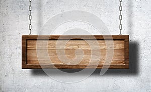 Oblong wooden sign hanging on chains with concrete wall background