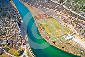 Obrovac. Soccer field by Zrmanja river aerial view. Karst landscape of Obrovac