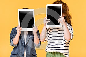 obscured view of kids holding tablets with blank screens