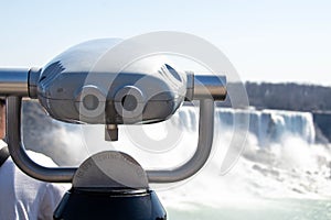 Observation binoculars close-up with a view of the river