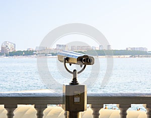 observation binoculars on the white promenade of the resort town. the concept of vacation and recreation at the sea