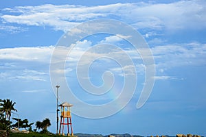 Observation small tower for lifeguard with rainbow seaside