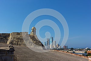 Observation tower of San Felipe de Barajas fortress with a view on modern cityscape of Cartagena, Colombia.