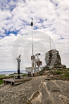 Observation viewpoint with binoculars, visitors box and a pile of stones at Mastravarden hill top at Mosteroy island