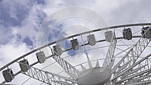 observation wheel against the sky. big wheel against blue sky. Ferris Wheel Against a Blue Sky