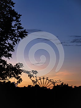 Observation wheel in the distance with sunset background in Kyiv