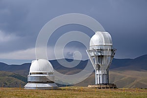 Observatory telescope on green valley among mountains mountains in day, great design for any purposes.