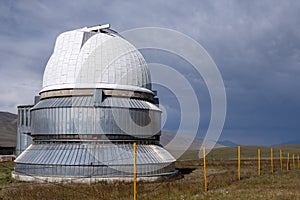 Observatory telescope on green valley among mountains mountains in day, great design for any purposes.