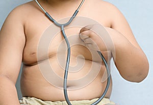 Obses boy check heart by stethoscope