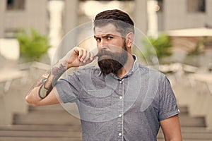 Obsessed about his moustache. Bearded man twirl moustache urban outdoor. Hipster wear long beard and moustache. Beard