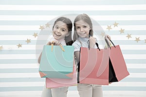 Obsessed with shopping and clothing malls. Discount concept. Kids cute girls hold shopping bags. Shopping discount