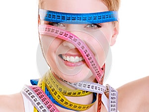 Obsessed sporty fit woman with measure tapes. Time for diet slimming.