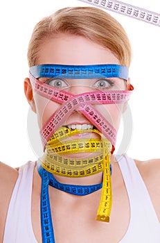 Obsessed sporty fit woman with measure tapes. Time for diet slimming.