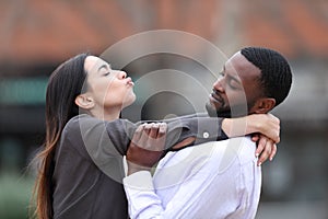 Obsessed woman trying to kiss a man who rejects her in the street