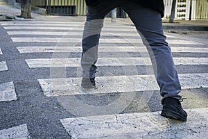Obsessive compulsive disorder, man trying not to step on the black lines of a pedestrian crossing