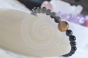 obsidian and tiger eye stone bracelet On selenite stone .