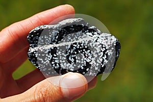 Obsidian volcanic rock from United States held in a hand