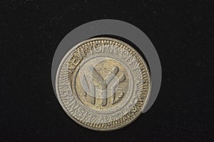 An obsolete New York City subway token photo