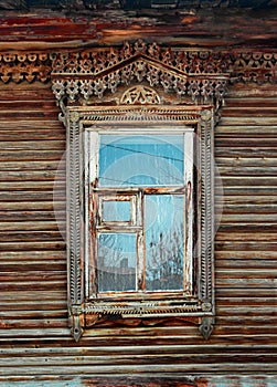 Obsolete ornate carved wooden window in old russian style