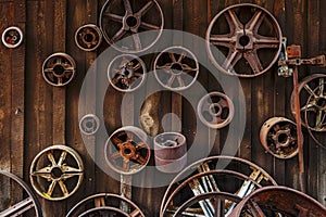 Obsolete rusty industrial parts on shed wall