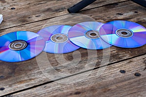 Obsolete set of CDs on a wooden table. Digital transition over a decade photo