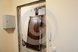 Obsolete steel door is deinstalled from doorframe, flat renovations