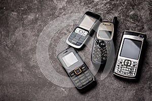 Obsoleted cellphones on a grunge background