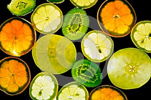 Different fruit slices in backlight photo