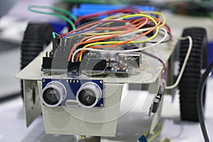 Obstacle avoiding robot made using programmable micro controller and ultrasonic sensor along with dc motors and wheels as a STEM