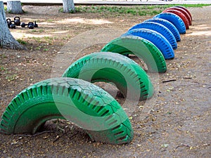 Obstacle course of old car tires dug into the ground