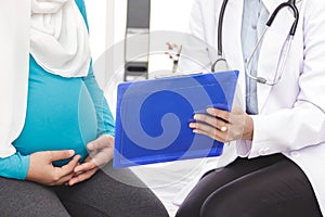 Obstetrician explaining the result of examination to her patient photo