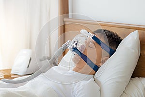 Obstructive sleep apnea therapy, Man wearing CPAP mask.