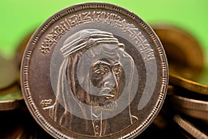 Obverse side of an Egyptian one pound coin, 1 LE coin year 1976, 1396 AH with Bust of King Faisal half right, Translation ( photo