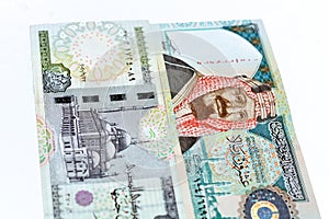 Obverse sides of Saudi Arabia 20 twenty riyals banknote with 20 LE twenty Egyptian pounds bill isolated on a white background,