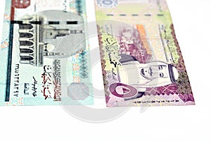 The obverse sides of Saudi Arabia 5 five riyals banknote with 5 LE five Egyptian pounds bill isolated on a white background,