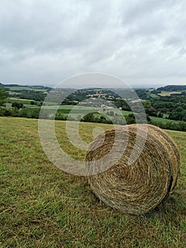 occitanie straw bale in a field and in the distance Montolieu village du livre