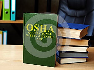 Occupational Safety and Health Act OSHA book and stack of laws.