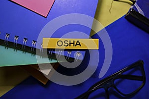 Occupational Safety and Health Administration Osha on sticky Notes isolated on Office Desk Background.